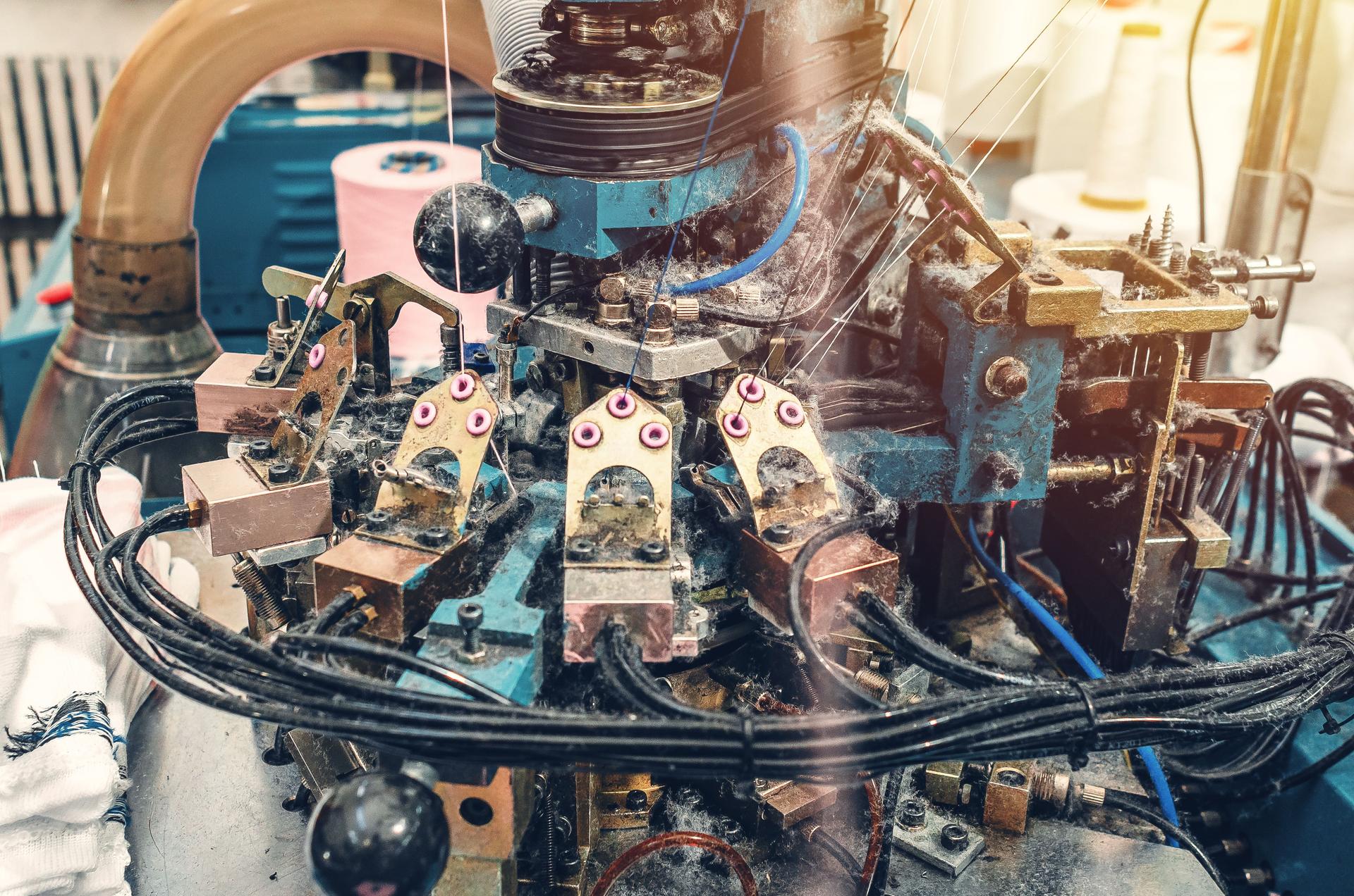 Clear view of sock knitting machine in operation. Machinery and equipment in textile production. Production process.