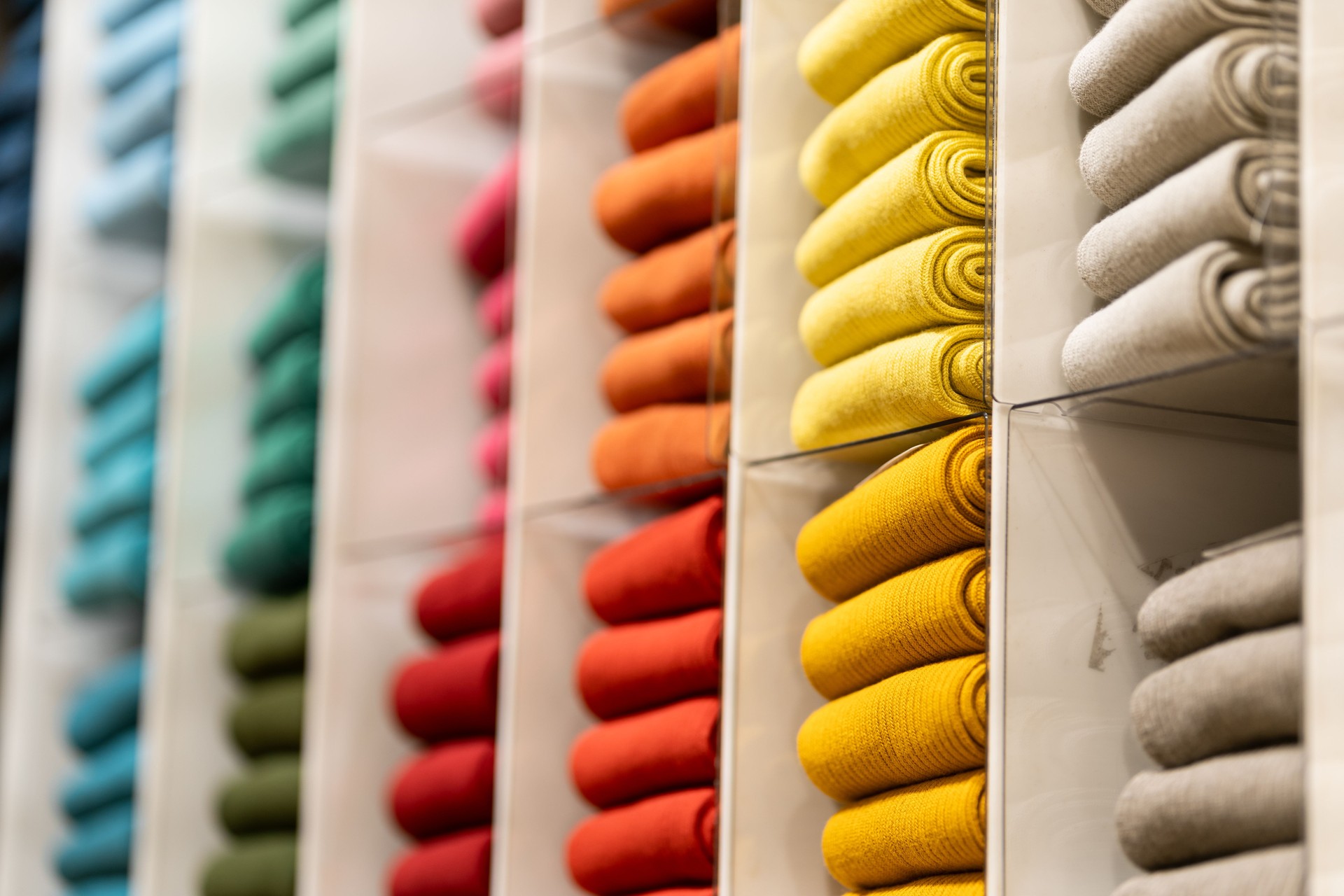 Multi color socks stacked for display at the store. colorful socks selective focus